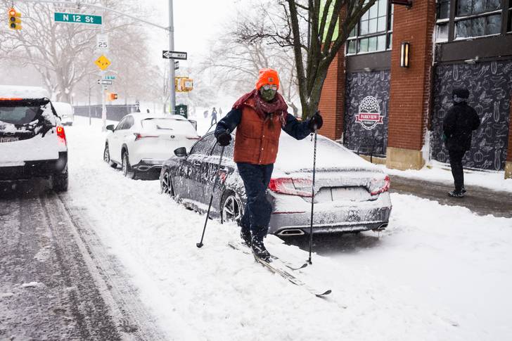 a person skiing on a Williamsburg sidewalk